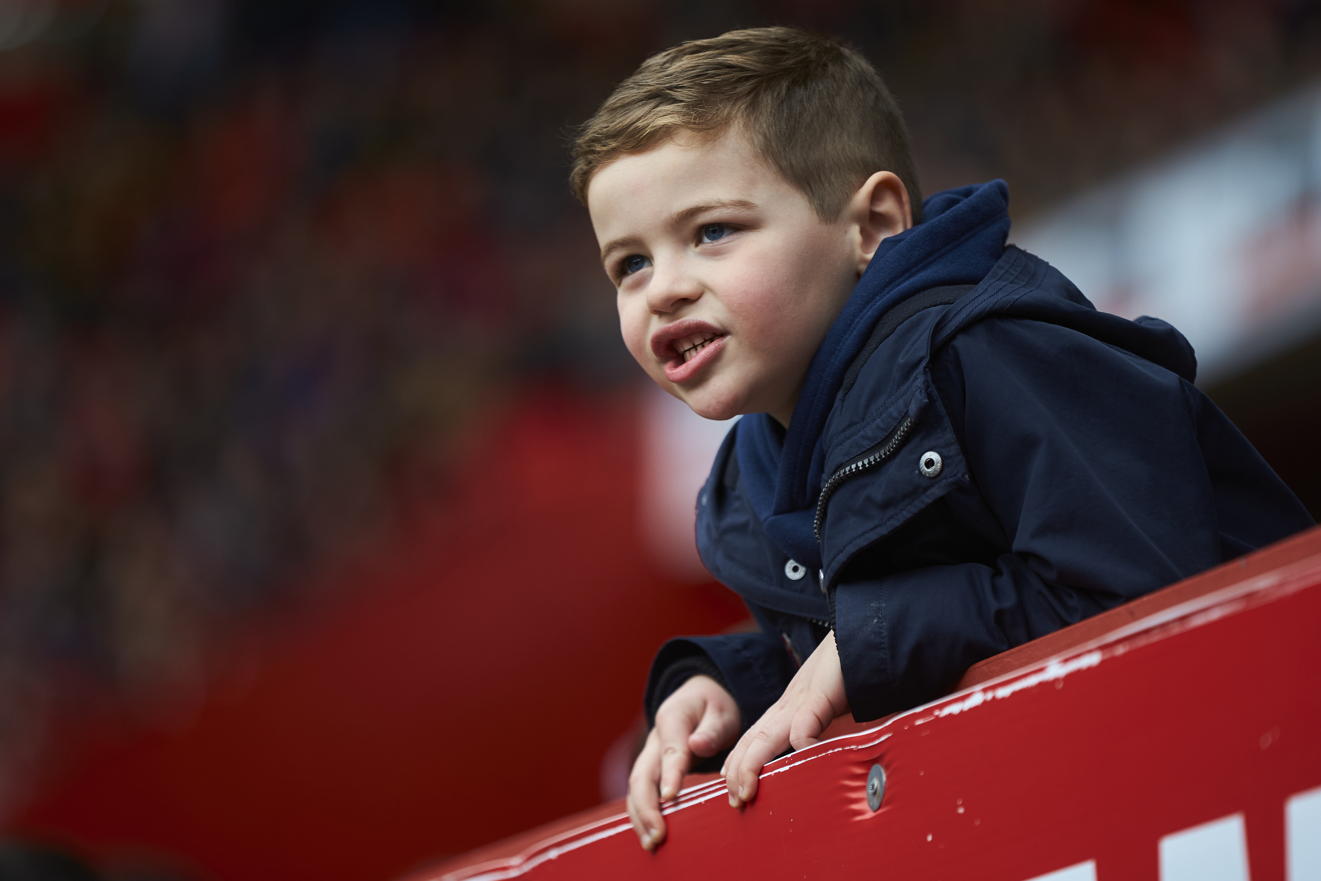 A young Charlton supporter cheers on from the stands