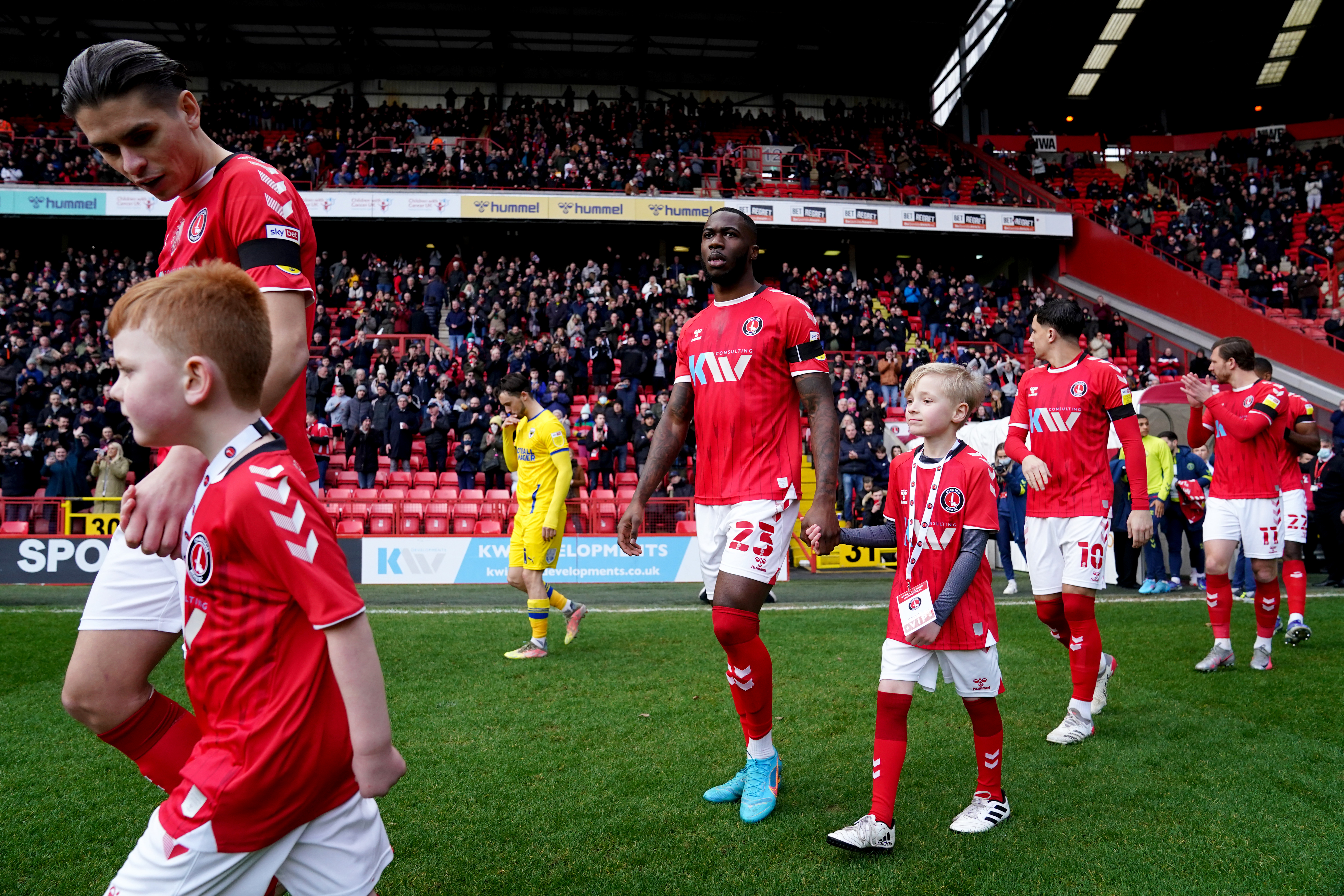 George Dobson walks out with a mascot at The Valley