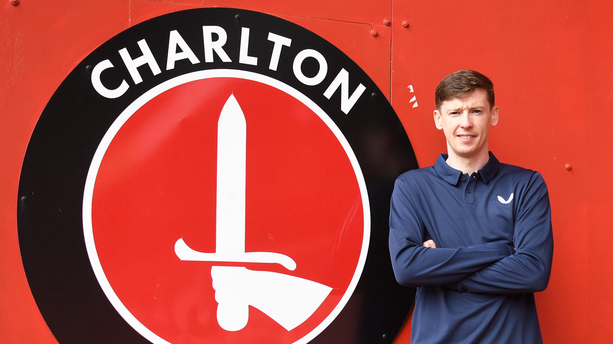 Conor McGrandles pictured next to the Charlton Athletic badge in the Covered End