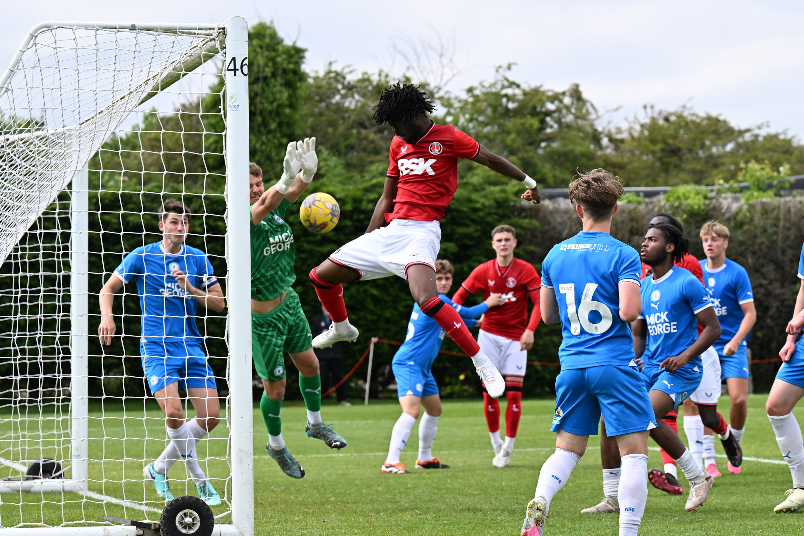 Tolu Ladapo jumps with Jake West as the ball goes into the net.