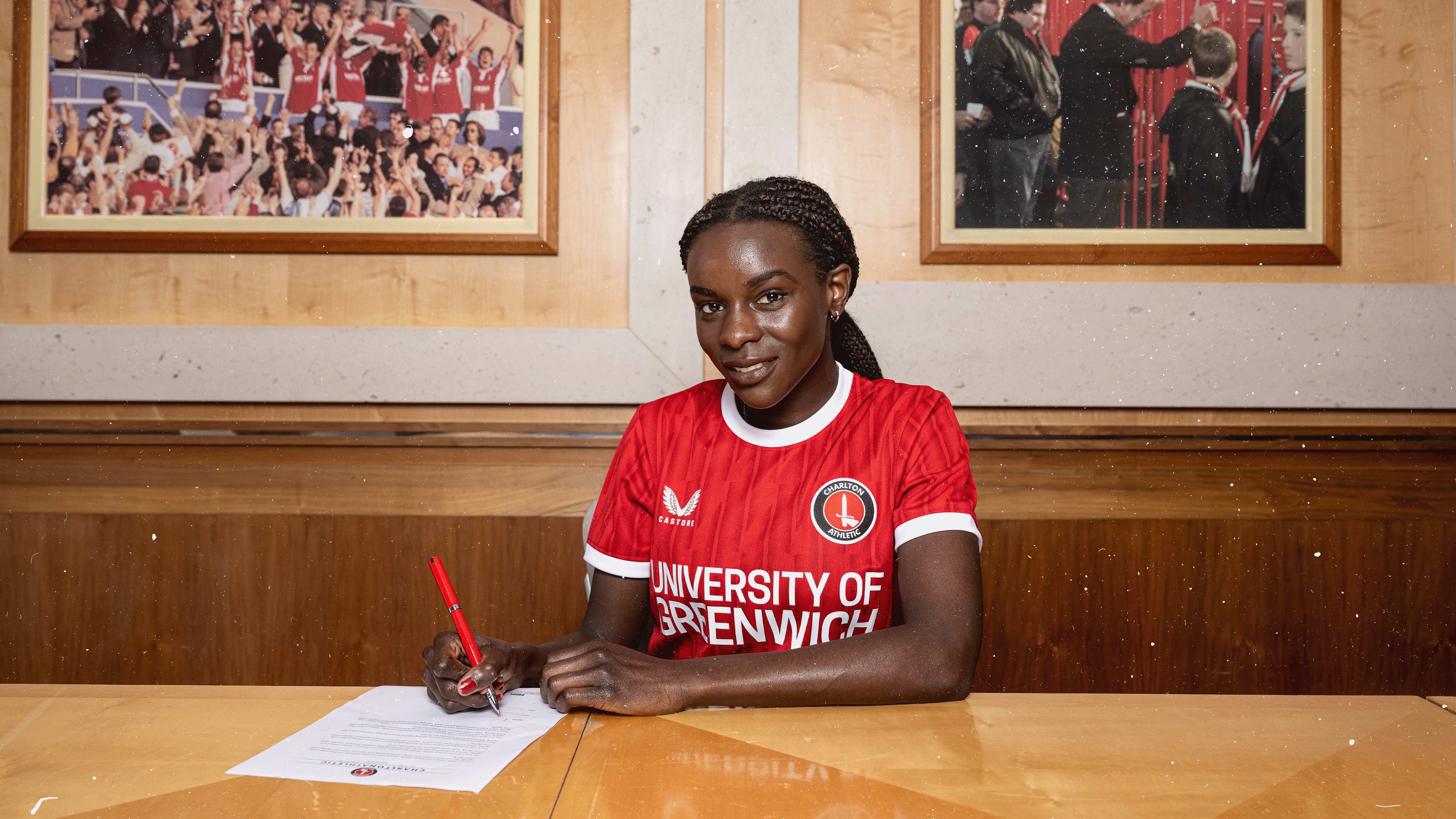 Karin Muya signing her contract