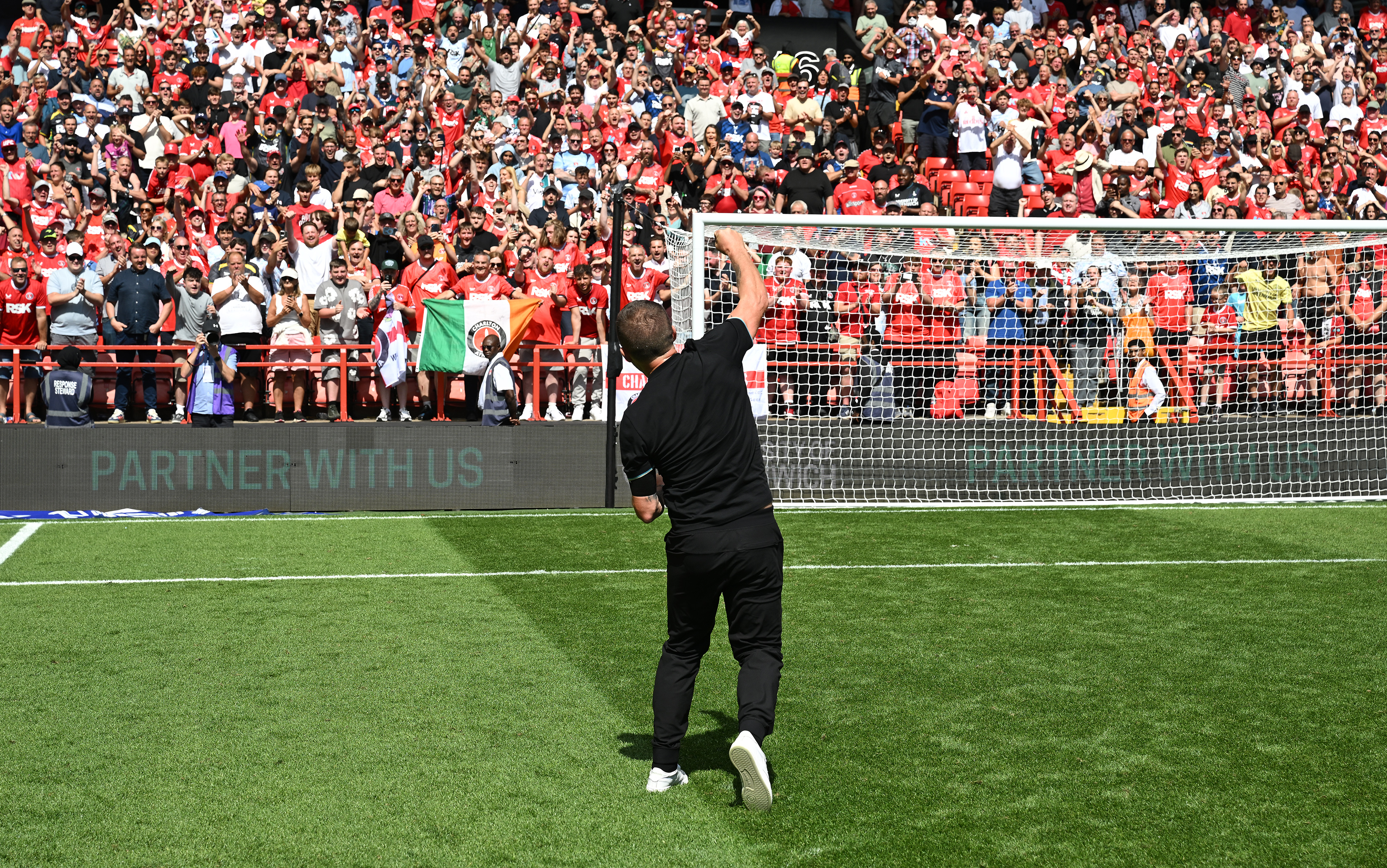 Nathan Jones celebrates in front of the Covered End