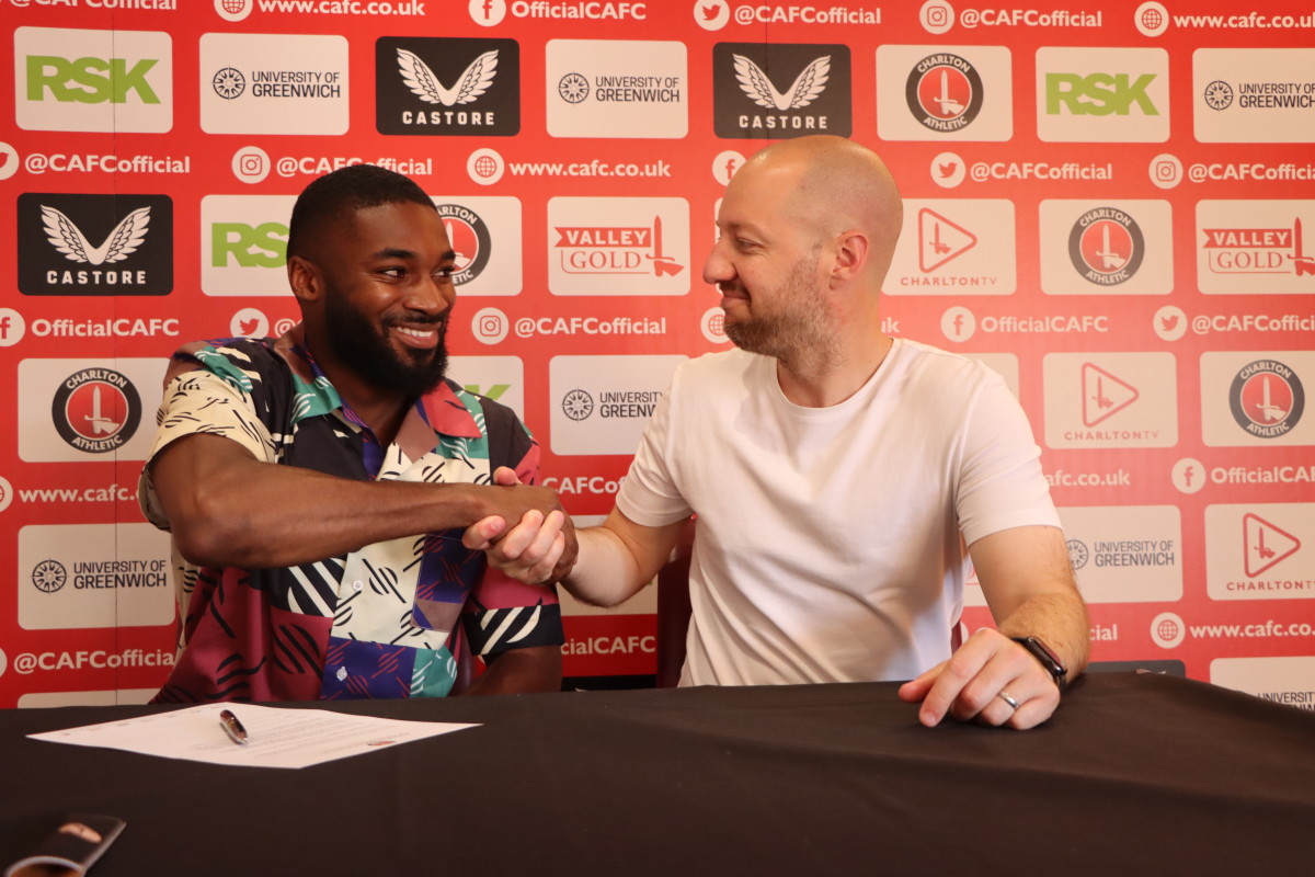 Ben Garner shakes hands with Mandela Egbo, his second summer signing