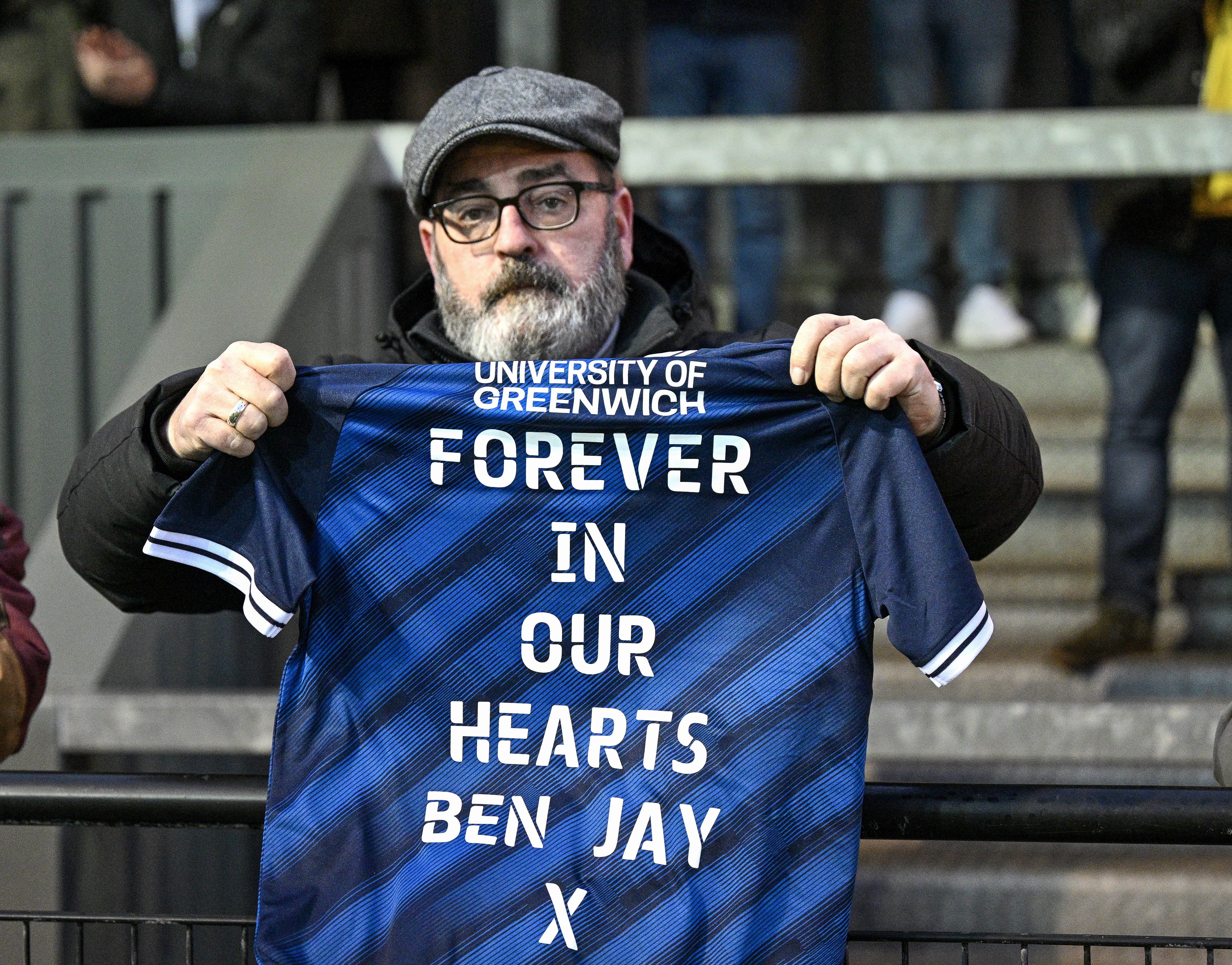 A friend of Ben Jay's family holding up the shirt at full time