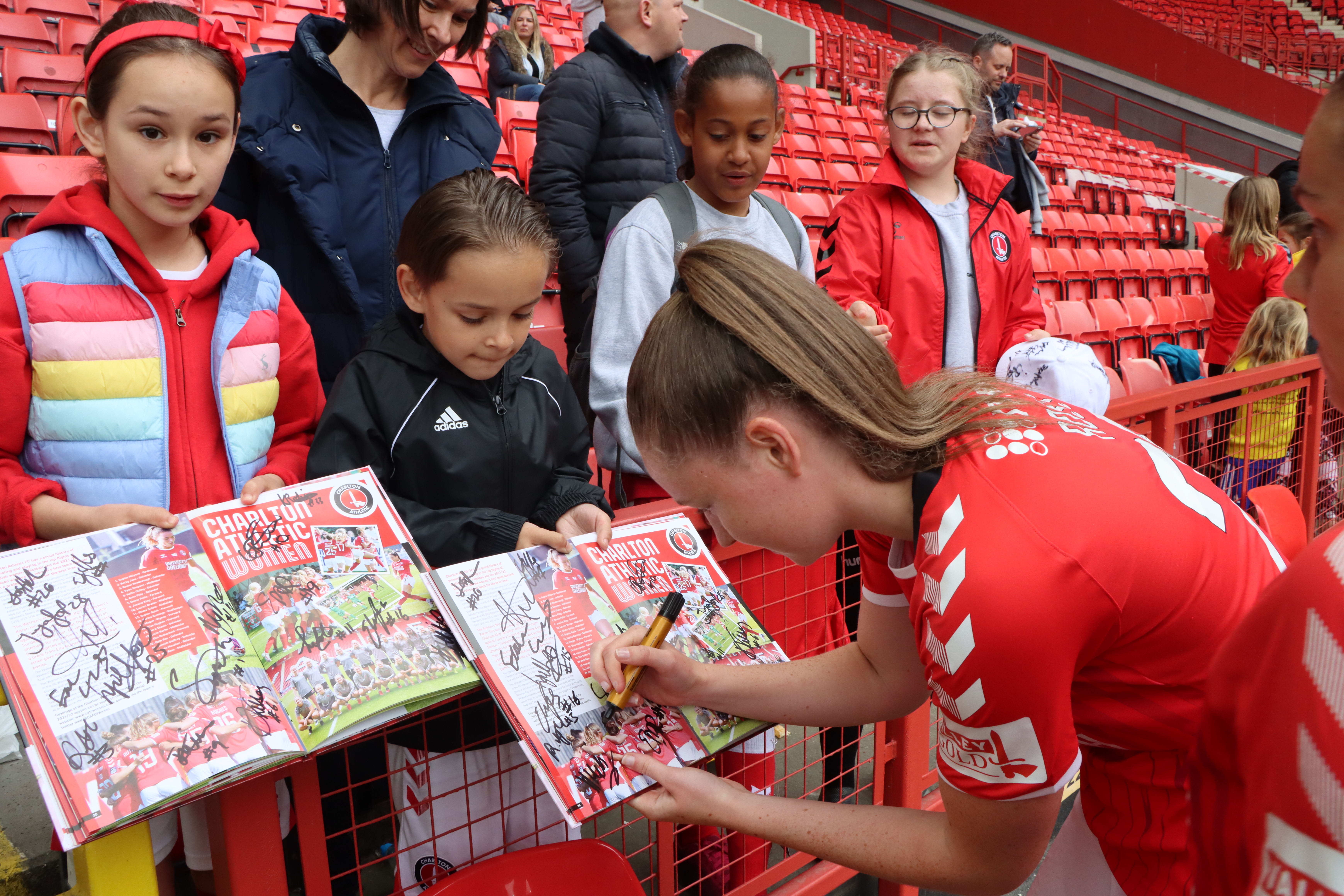 Mia Ross signs autographs for young Charlton supporters after the Addicks' match against Durham Women at The Valley