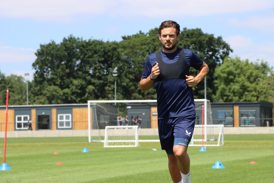 Jake Forster-Caskey pictured running on the training pitches