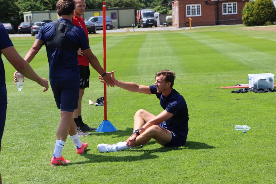 Jake Forster-Caskey helps Alex Gilbey back to his feet