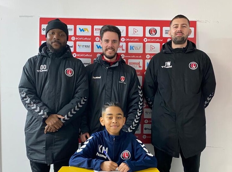 Kyan May signing his contract with CAFC and CACT staff