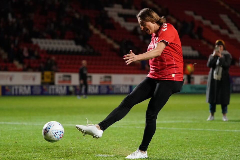 Naomi Reid kicking a football at The Valley