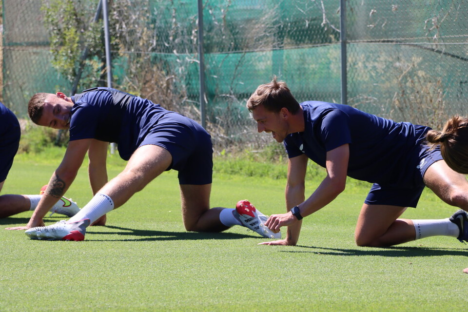 Sam Lavelle and Alex Gilbey smile while stretching