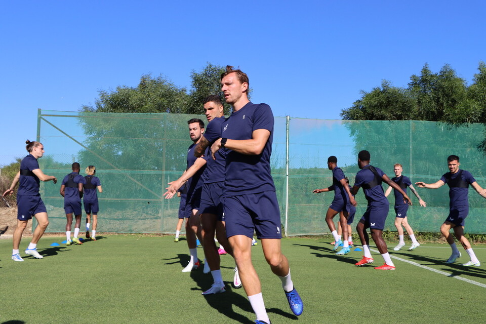 The Addicks squad warm up ahead of training