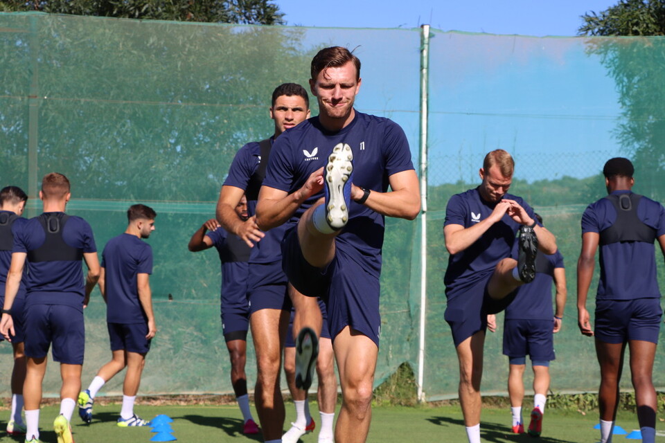 Alex Gilbey performs a dynamic stretch ahead of training