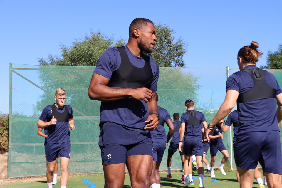 Chuks Aneke warms up ahead of training