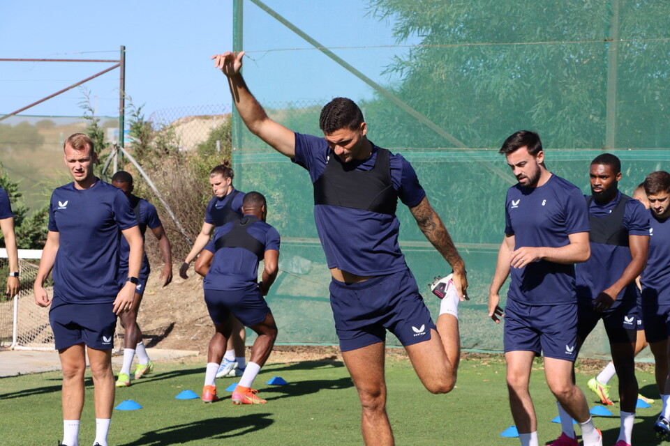 The Addicks squad warm up ahead of training