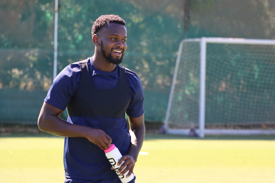 Diallang Jaiyesimi smiles with a drinks bottle in hand