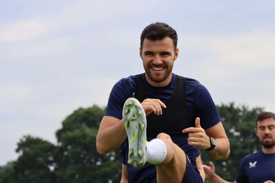 Scott Fraser performs a dynamic stretch ahead of training