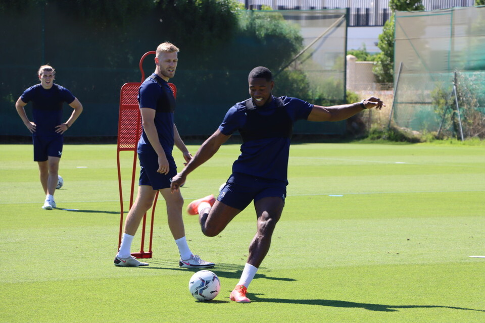 Chuks Aneke smiles as he unleashes a shot towards goal