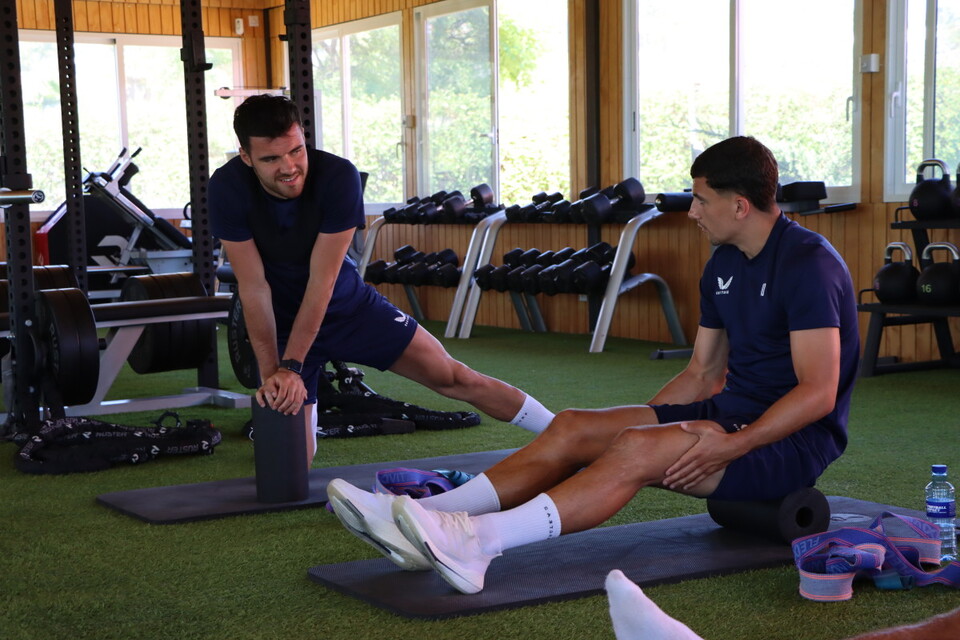 Albie Morgan in conversation with Scott Fraser while using a foam roller in the gym