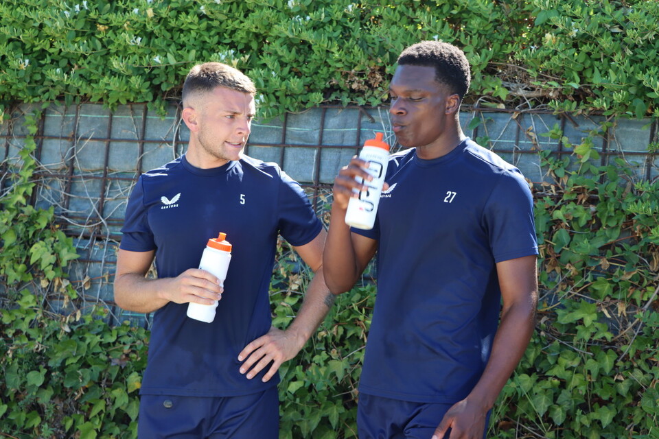 Sam Lavelle and Deji Elerewe rehydrate in the Spanish sun