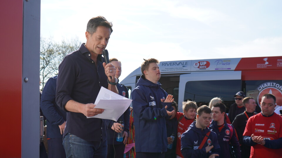 Scott Minto presenting with microphone