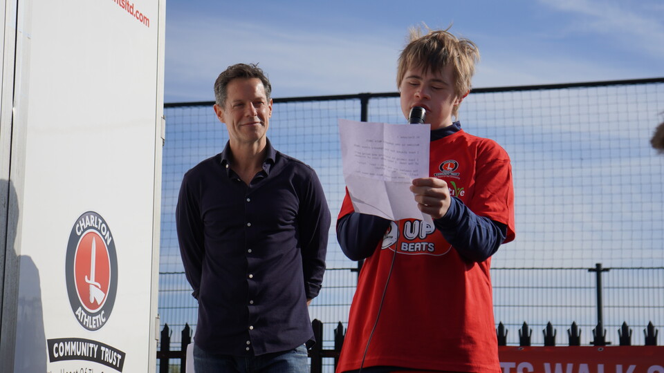 Upbeat Taylor giving a speech with Scott Minto behind him