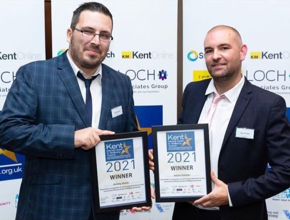 Adam Palmer collecting an award