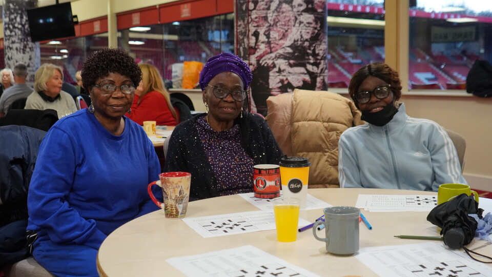 Extra Time members posing for a photo at the table