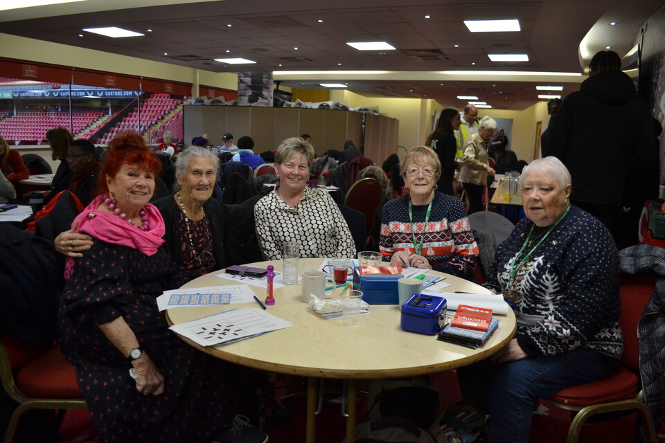 Extra Time members posing for a photo at the table