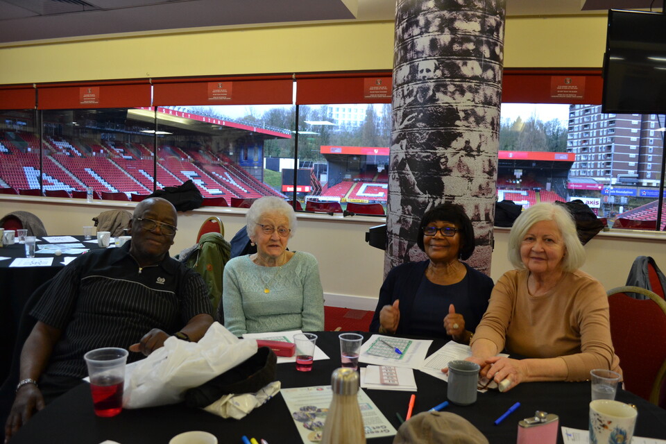 Extra Time members posing for a photo at the table