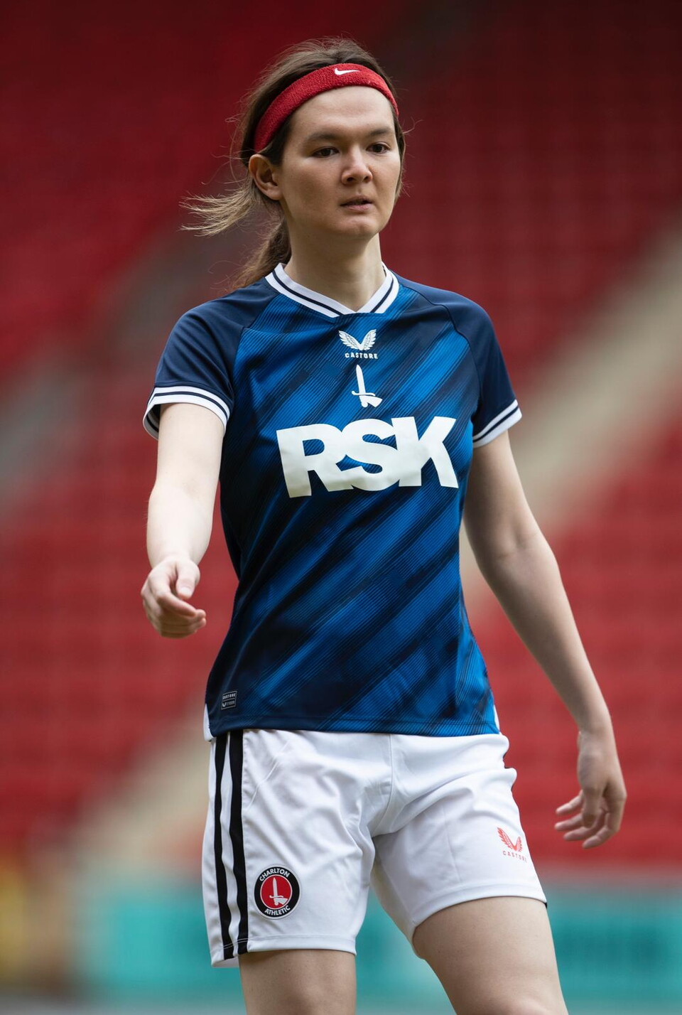 Portrait of Charlton Invicta player Julia in her kit who shared her story for Trans Awareness Week