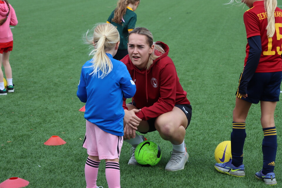 Charlton Athletic women's player Sian Rogers meeting a young Wildcats player