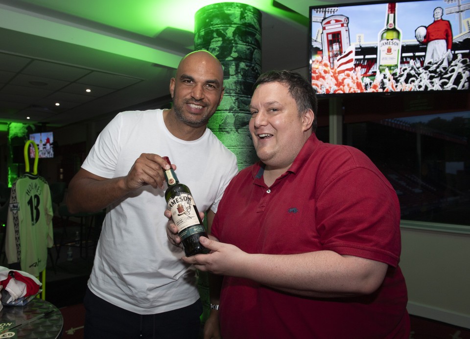 Jonathan Fortune holds a signed Jameson Bottle with a Charlton Athletic fan during a Charlton Legends Q&A in the Meantime Fans’ Bar at The Valley, London