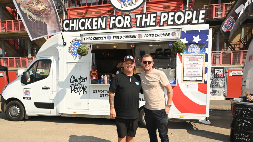 Charlton Athletic manager Nathan Jones with Chris Chea from Chicken George during the Family Fun Day for the Summer Holidays at The Valley, London