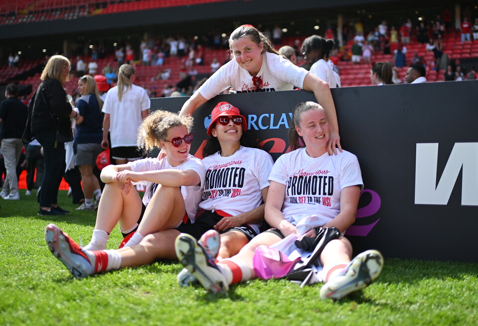 Players in front of winners sign