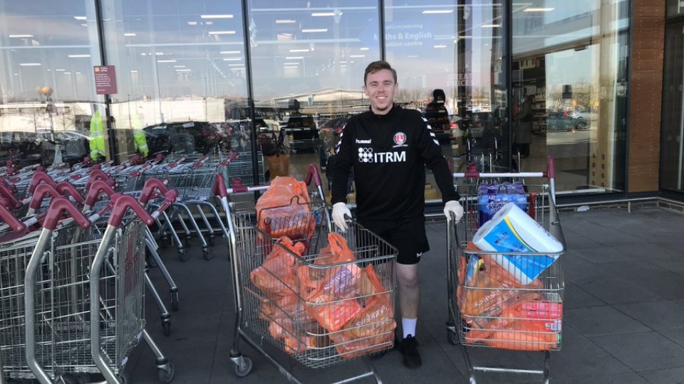 CACT staff member posing with shopping for vulnerable people in the community