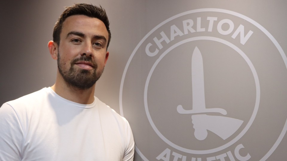 Eoghan O'Connell pictured alongside a white Charlton badge after signing a three-year deal with the Addicks