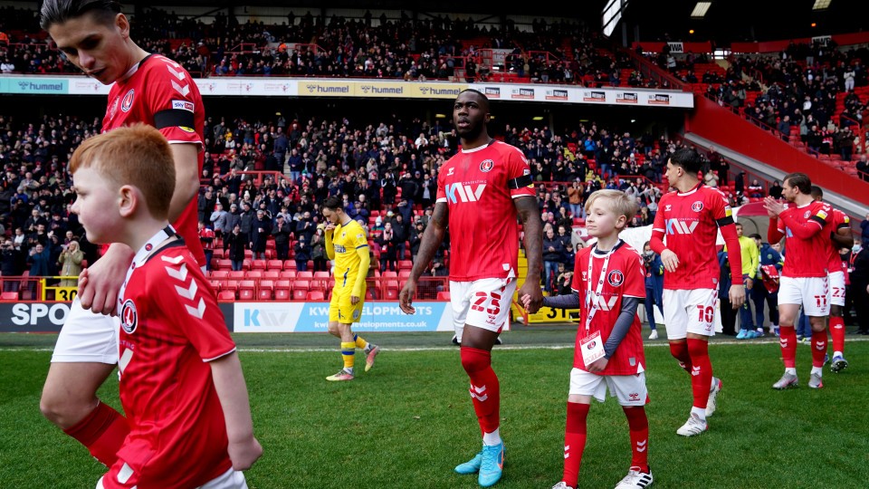 George Dobson walks out with a mascot at The Valley