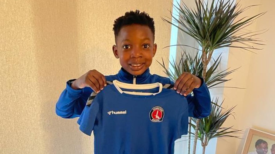 Malachi holding up his new Charlton kit