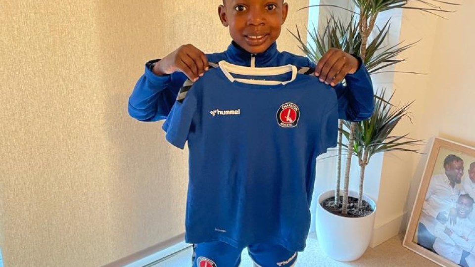 Malachi holding up his new Charlton kit