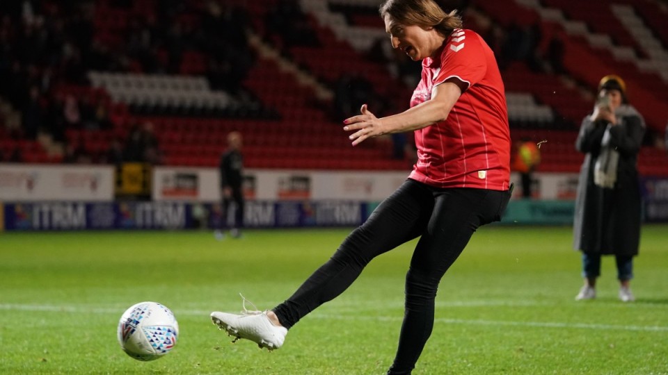 Naomi Reid kicking a football at The Valley