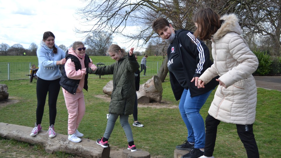 Short Breaks participants at a park with a CACT staff member