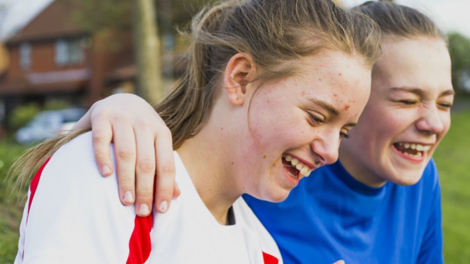 Two young people laughing