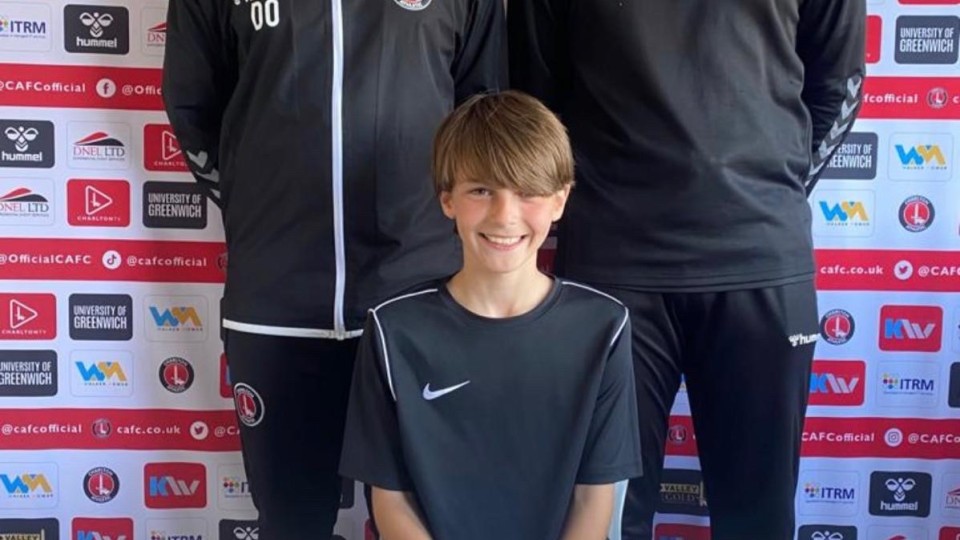 Enrik signing his contract alongside club staff
