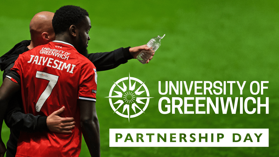 Ben Garner giving instructions to Diallang Jaiyesimi with University of Greenwich branding on the back of his shirt