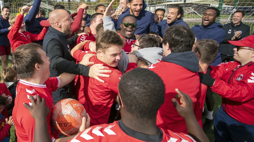 Charlton players and Upbeats celebrate together