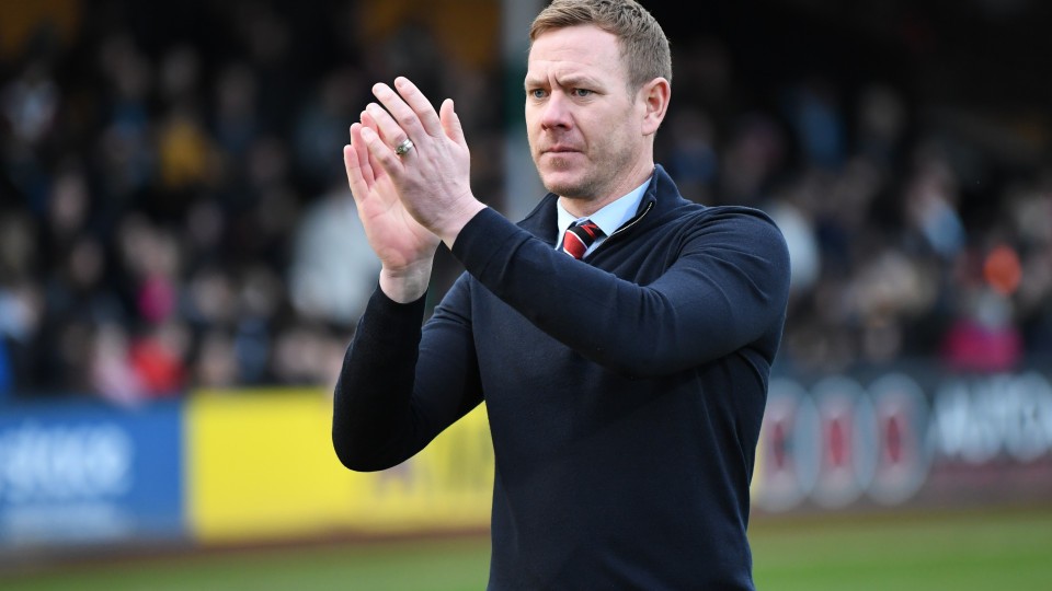 Dean Holden claps supporters