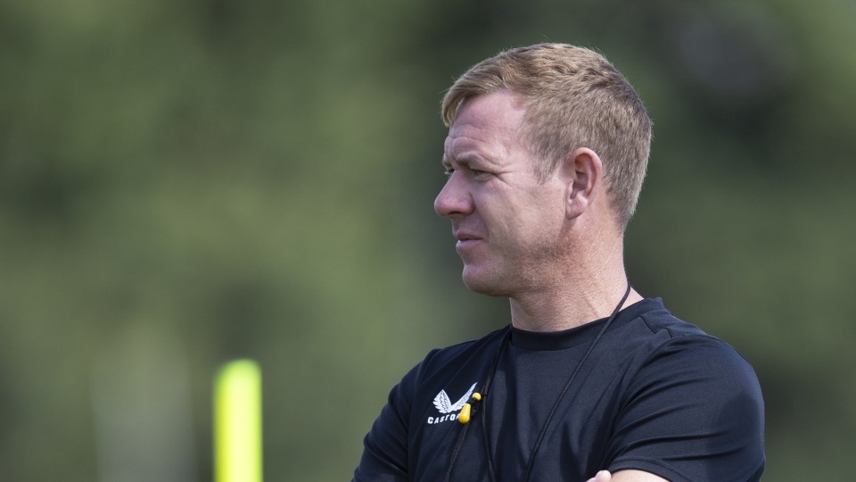 Dean Holden watches training