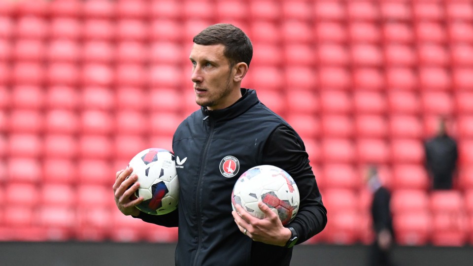 Jason Pearce with two footballs