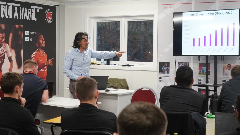 Dr Michael Seeraj at the front of a classroom with Academy staff sat at desks facing him