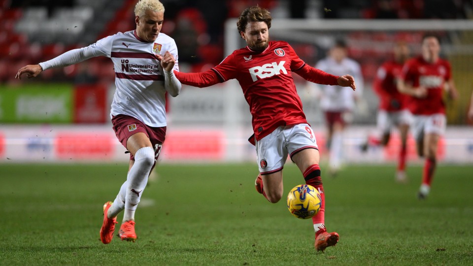 Alfie May battles for the ball